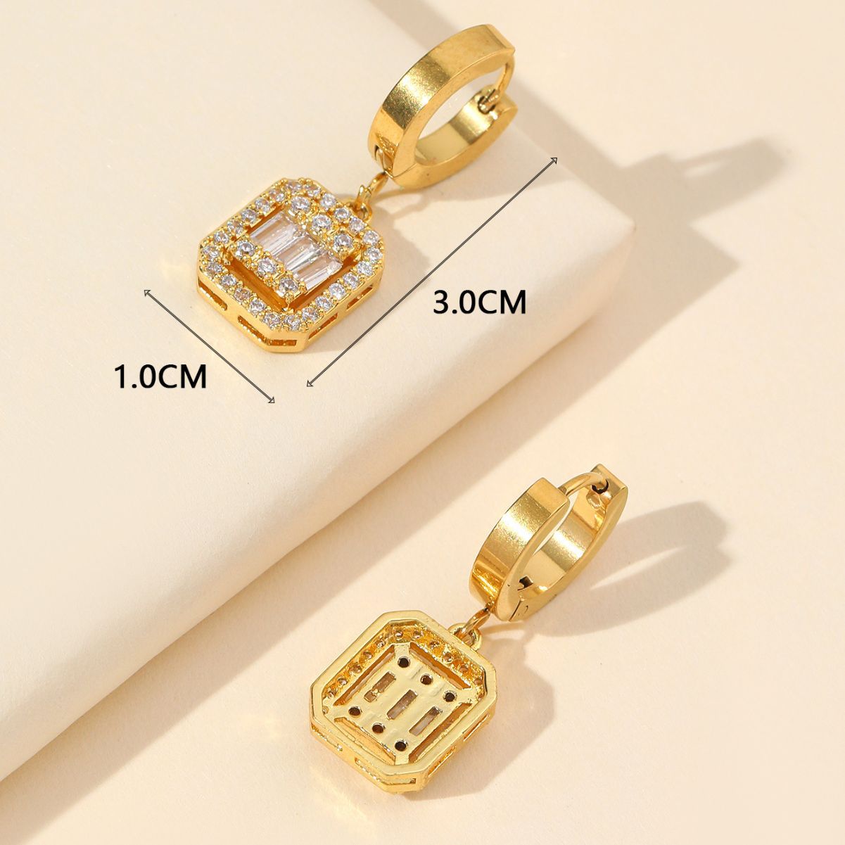 Gold huggie earrings with cubic zirconia