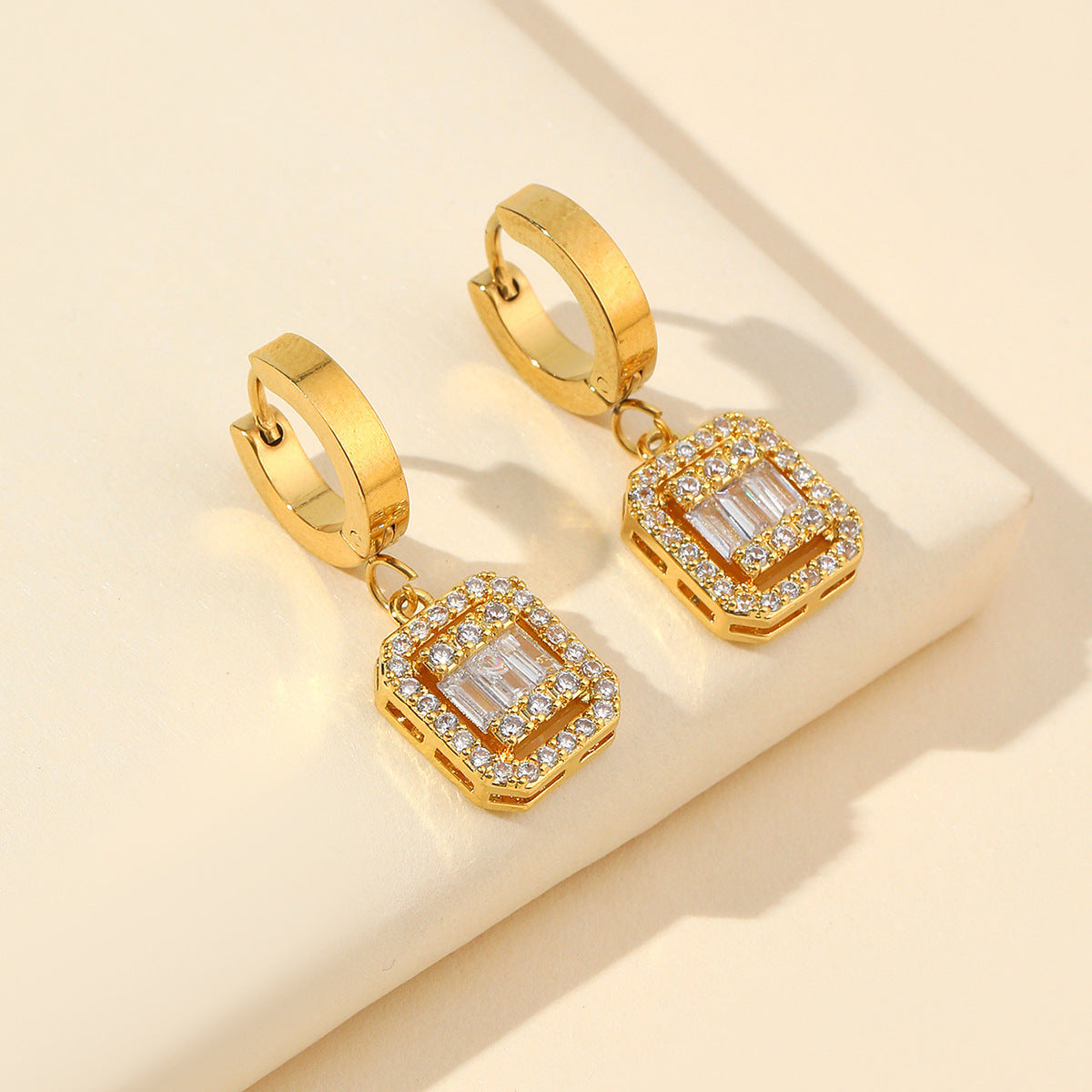Gold huggie earrings with cubic zirconia
